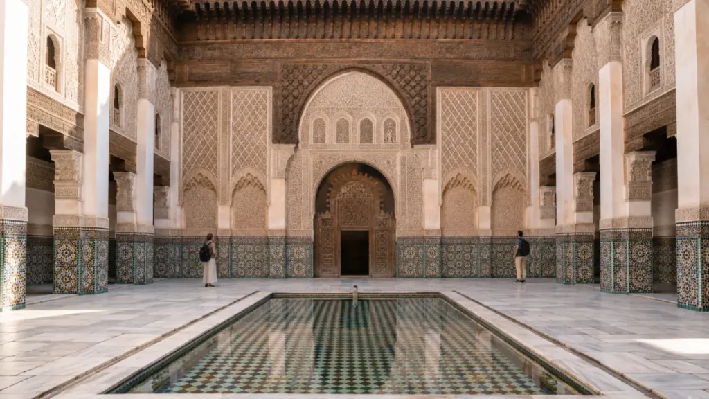Historic Marrakech madrasa courtyard with zellige tiles and reflecting pool
