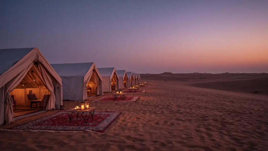 Luxury desert camp with white tents and lanterns on a Morocco desert tour from Casablanca